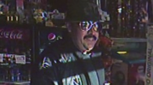 Police are searching for a man seen smiling following a robbery in Buena Park. The robbery was caught on surveillance video and shared by the store's owner. 