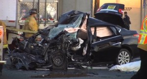 A black sedan was destroyed in a crash with a big rig in Gardena on Dec. 23, 2015. (Credit: Street Heat Productions)