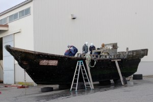 Coast guard officials on Nov. 24, 2015, investigate a wooden boat at the Fukui port in Sakai city in Fukui prefecture, western Japan, after the ship was found drifting off the coast of Fukui. (Credit: JIJI PRESS/AFP/Getty Images) 