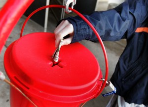 A donation is made into a Salvation Army red Holiday donation kettle on Dec. 20, 2005 in Park Ridge, Illinois. (Credit: Tim Boyle/Getty Images)