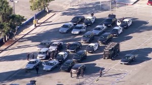 Los Angeles Police Department patrol cars and SWAT vehicles were staged outside the Los Angeles Memorial Coliseum following an unspecified threat to several LAUSD schools on Dec. 15, 2015. (Credit: KTLA)