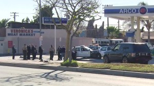 Officials investigate a deadly shooting in Lynwood on Dec. 12, 2015. Two sheriff's deputies opened fire on a man they say was armed with a gun. (Credit: KTLA)