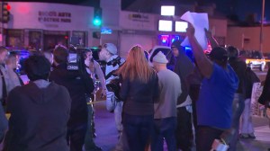 Dozens of people gathered, several apparently angry, after video emerged showing deputies fatally shooting a man in Lynwood on Dec. 12, 2015. (Credit: KTLA)