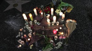 Candles and flowers surrounded David Bowie's star on the Hollywood Walk of Fame on Monday, Jan. 11, 2016, a day after his death was announced. (Credit: Mark Mester/ KTLA)