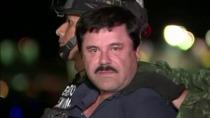 Mexican forces escorted Joaquin "El Chapo" Guzman out of an armored vehicle and into a helicopter late Friday night following his arrest after months on the run. (Credit: CEPROPIE via CNN)