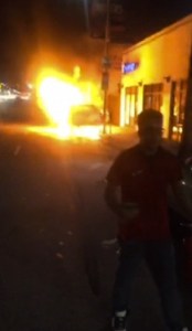 A witness's cellphone video shows a man holding a fire extinguisher near a truck fire on Sunset Boulevard in East Hollywood on Jan. 24, 2016. (Credit: Daniel Mirzakhanian)