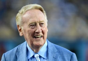 Los Angeles Dodgers broadcaster Vin Scully smiles on the field before the game against the Arizona Diamondbacks at Dodger Stadium on Sept. 23, 2015. (Credit: Harry How/Getty Images)