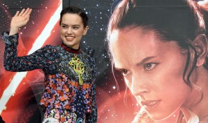 Actress Daisy Ridley waves as she appears at a press conference to promote "Star Wars: The Force Awakens" in Urayasu, a suburb of Tokyo, on Dec. 11, 2015. (Credit: TORU YAMANAKA/AFP/Getty Images)