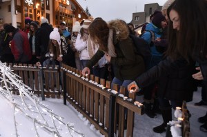 People lay candles in tribute to the victims of the avalanche, on Jan. 14, 2016, at Les Deux Alpes resort in the French Alps, a day after an avalanche swept away skiers, including a group on a school outing. (Credit: PHILIPPE DESMAZES/AFP/Getty Images)