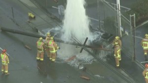 A man remained trapped in a pickup truck in Montebello after hitting a fire hydrant and telephone pole on Jan. 12, 2016. (Credit: KTLA)