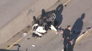 The crash left the officer's motorcycle upside down near the center divider of the 170 Freeway. (Credit: KTLA)