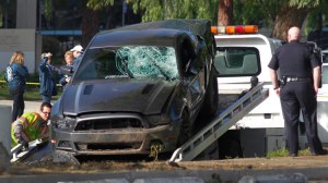 The Ford Mustang that struck three pedestrians, killing two of them, in Chatsworth is removed. (Credit: Brian van der Brug/Los Angeles Times)