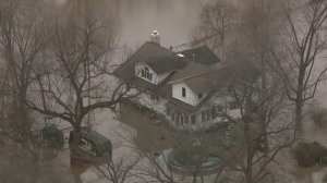 A home in New Athens, Illinois, is surrounded by flood waters on Dec. 31, 2015. (Credit: KMOV)