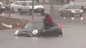 A driver was stranded when his Mini Cooper became stuck in floodwater near the Sepulveda Basin on Jan. 5, 2016. (Credit: First In) 