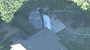 A jogger was fatally struck by a vehicle, ending up in a Walnut yard, on Feb. 15, 2016. (Credit: KTLA)