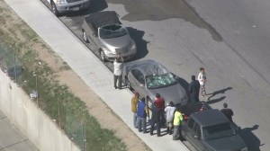 At least two vehicles were damaged in the crash of a small plane in Pacoima on Feb. 22, 2016. (Credit: KTLA)