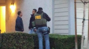 FBI officials are seen on Feb. 18, 2016, at a Corona home believed to be the residence of San Bernardino mass shooter Syed Rizwan Farook’s brother. (Credit: Andrew Stephens)