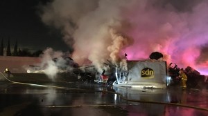 A fiery crash involving an overturned big rig in the Commerce area shut down both sides of the 5 Freeway on Feb. 27, 2016. (Credit: John A. Moreno/KTLA)