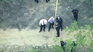 Police investigate the discovery of two female bodies in Debs Park on Oct. 28, 2015. (Credit: KTLA)