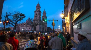 People stake out spots at dawn near the cathedral to see the Pope arrive in Morelia, Michoacan. (Credit: Brian van der Brug/Los Angeles Times)