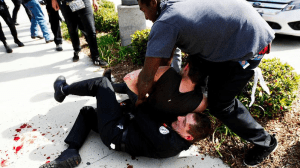 Protesters scuffle with a Ku Klux Klansman after members of the KKK tried to start a "White Lives Matter" rally at Pearson Park in Anaheim. The event quickly escalated into violence. (Credit: Luis Sinco / Los Angeles Times)