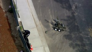 A bomb squad robot stands as a sheriff's official investigates on the Valley College campus on March 30, 2016. (Credit: KTLA)