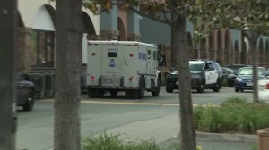A Brink's truck remains at the scene where its guard was robbed at a Granada Hills strip mall on March 29, 2016. (Credit: KTLA)
