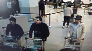 This picture released by Belgian police on March 22, 2016, shows suspects in the Brussels attacks. Two were thought to have committed suicide attacks, while the man in the light jacket and hat was being sought.