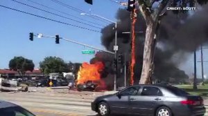 A witness's video shows an overturned pickup truck engulfed in flames after a six-vehicle crash in Torrance on March 12, 2016. (Credit: Scott)