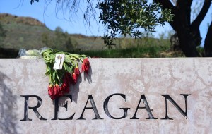 A wilted bouquet of flowers lays a top the sign outside the Ronald Reagan Presidential Library in Simi Valley, where people pay their respects to the late Nancy Reagan on March 9, 2016. (Credit: FREDERIC J. BROWN/AFP/Getty Images)