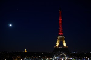 A picture taken on March 22, 2016, shows the Eiffel Tower in Paris illuminated in colors of the Belgian flag in tribute to the victims of terrorist attacks in Brussels. (Credit: LIONEL BONAVENTURE/AFP/Getty Images)