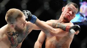 Conor McGregor, left, get the better of this exchange of punches with Nate Diaz during their welterweight fight at UFC 196. (Credit: Wally Skalij/Los Angeles Times)