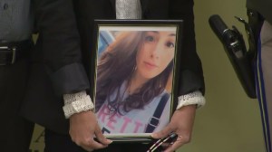 Gigi Littlefield holds a picture of her daughter Michelle at a news conference on March 23, 2016. (Credit: KTLA)