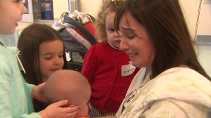 Niccole Connally holds her son Noah as he joins her daughters after his third heart surgery, at CHOC on March 8, 2016. (Credit: KTLA)