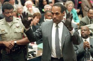 O.J. Simpson shows the jury a new pair of Aris extra-large gloves, similar to the gloves found at the Bundy and Rockingham crime scene June 21, 1995, during his double-murder trial in Los Angeles. (Credit: VINCE BUCCI/AFP/Getty Images)