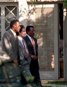 Murder defendant O.J. Simpson, left, returns to his Rockingham estate for the first time since his arrest on June 17, 1994. He’s seen during a jury tour on Feb. 12, 1995, with friend Robert Kardashian, center, and his lead attorney Johnnie Cochran Jr. (Credit: POO/AFP/Getty Images)