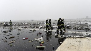 Russian emergency rescuers work on the wreckage of the flydubai passenger jet which crashed, killing all 62 people on board as it tried to land in bad weather in the city of Rostov-on-Don on March 19, 2016. (Credit: AFP/Getty Images)