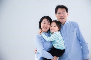 The deceased girl is seen in an undated photo with her parents. (Credit: Claire Wang/via CNN)