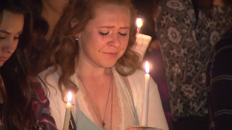 A mourner attends a vigil for Michelle Littlefield and Brian Lewandowski at College of the Canyons on March 2, 2016. (Credit: KTLA) 