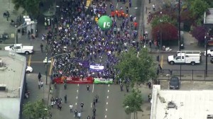 Protesters move through downtown Los Angeles in a march to demand a $15 minimum wage on April 14, 2016. (Credit: KTLA)