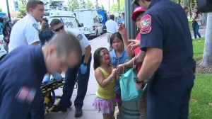 A little girl cries after five people are pepper-sprayed at a Trump-related rally in Anaheim on April 26, 2016. (Credit: KTLA)