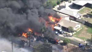 The fire spread to vehicles and a home in Montclair on April 4, 2016. (Credit: KTLA)
