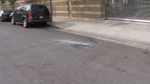 Glass remained at the scene where LAPD officers smashed the window of a vehicle in which a sex assault was taking place in Westlake on April 3, 2016. (Credit: KTLA)