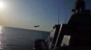 Russian fighter jet is seen flying close to a U.S. destroyer in international waters. (Credit: CNN)