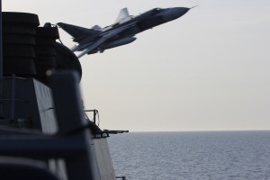 A Russian Sukhoi Su-24 attack aircraft makes a very low-altitude pass by USS Donald Cook April 12, 2016, in this photo released by the U.S. Navy.