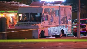 A taco truck is seen in the parking lot where a fatal shootout took place on April 19, 2016. (Credit: KTLA)