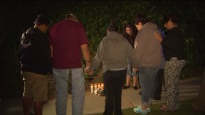 Flowers and candles mark the spot where 14-year-old Ivette Macias died in a crash on a street in Whittier on April 26, 2016. (Credit: KTLA)