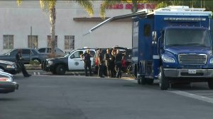 Officers are seen at a command post in Long Beach after police shot and killed a person in the area on May 7, 2016. (Credit: KTLA)