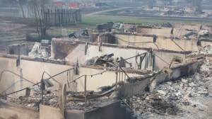 Home foundations are all that remain in a residential neighborhood destroyed by a wildfire on May 6, 2016 in Fort McMurray, Alberta, Canada Wildfires, which are still burning out of control, have forced the evacuation of more than 80,000 residents from the town. (Credit: Scott Olson/Getty Images) 