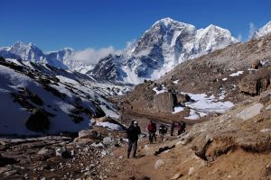 In this photograph taken on April 24, 2015, trekkers and climbers make their way up a trail leading to the village of Gorak Shep and Everest Base Camp a few days before a 7.8-magnitude quake struck on April 25, killing more than 8,800 people across the Himalayan nation and triggering a deadly avalanche on Mount Everest that killed 18 people. (Credit: ROBERTO SCHMIDT/AFP/Getty Images)